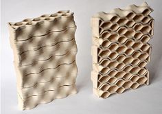 two sculptures made out of clay sitting next to each other