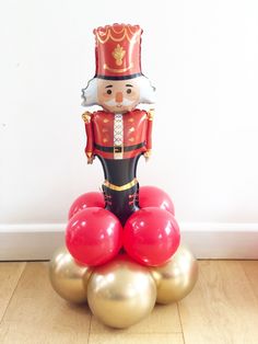 a nutcracker statue sitting on top of balloons