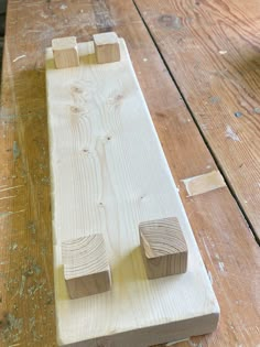 a piece of wood that has been cut into pieces and is sitting on top of a wooden table