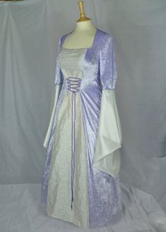 This dress will be made to your measurements.Please send your bust, waist and hip measurements and please measure from the top of your shoulder to the floor with shoes on. It will be made with lovely lilac or ivory crushed velvet and with a stunning ivory embroidered silk with silver detailing. The sleeves are part velvet and taffeta. It has a corset style front and back with lacing so you can adjust the dress to fit your body shape.Combined shipping on multiple items.If you purchase express shi Fitted Purple Bridesmaid Dress For Banquet, Purple Fitted Floor-length Ball Gown, Customizable Length Ball Gown With Fitted Bodice, Purple Fitted Bridesmaid Dress For Wedding, Fitted Purple Bridesmaid Dress For Wedding, Costume Dress With Boned Bodice And Fitted Design, Fitted Costume Dress With Boned Bodice, Princess Style Floor-length Wedding Dress With Fitted Bodice, Fitted Dress With Boned Bodice For Costume