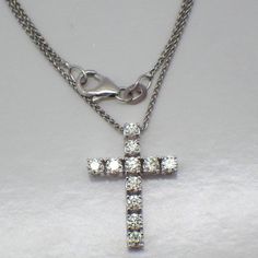 Vintage 14k (.585) white gold chain necklace with a cross pendant, decorated with Diamonds - approx. 0.7tcw, SI1-SI2 clarity, color J-K. This darling cross is 21 mm x 15 mm, the chain is 17 7/8" long and 1 mm wide, total weight is 3.7 grams. EA5027 White Diamond Cross Necklace Fine Jewelry, Fine Jewelry White Diamond Cross Necklace, White Cross Diamond Necklace Fine Jewelry, White Diamond Cross Necklace With Diamond Cut, White Diamond Cross Necklace With Brilliant Cut, White Brilliant Cut Diamond Cross Necklace, White Brilliant Cut Cross Diamond Necklace, White Gold Formal Cross Pendant Necklace, White Cross Necklace With Diamond Accents Fine Jewelry