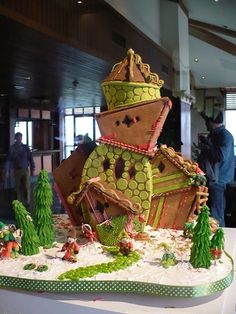 a large gingerbread house made to look like it's coming out of the woods