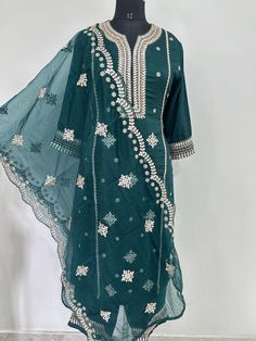 Salwar Kameez Set/Dresses For Women/Indian Wedding Dress/Pakistani Suit/ Kurta Palazzo Set / Kurtis for Women/ Silk Kurta Set Product Details Green Embroidered Kurta with Trousers with dupatta Kurta design: * Embroidered . Straight shape * Regular style *Round neck, three-quarter regular sleeves *l pocket zari detail * Calf length with straight hem * Chanderi silk machine weave fabric Trousers design: * Solid Trousers Partially elasticated waistband *Slip-on closure Material & Care Kurta Fabric: Silk Blend  Trouser Fabric: Silk Blend Dupatta Fabric: Organza Hand Wash items includes One piece Kurta One piece Dupatta One piece Trouser Note:- Please see the size chart in the image to choose a perfect size. Please feel free to ask any questions regarding this item WE ALSO ACCEPT CUSTOMISATION Fitted Embroidered Chinon Salwar Kameez, Fitted Embroidered Fabric With Gota Work For Festivals, Embroidered Fabric With Gota Work In Traditional Drape, Fitted Anarkali Embroidered Fabric With Gota Work, Fitted Chinon Embroidered Straight Kurta Fabric, Embroidered Chinon Dress For Diwali, Fitted Bollywood Embroidered Fabric With Gota Work, Embroidered Fitted Salwar Kameez For Eid, Summer Georgette Kurta With Dupatta