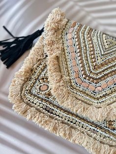 Cream toned beaded boho clutch bag with beading work and trim of tassels . Accompanied by braided leather sling Bohemian Clutch Bag With Tassels, Bohemian Tassel Clutch Bag, Bohemian Clutch Shoulder Bag With Tassels, Bohemian Tassel Clutch Shoulder Bag, Bohemian Clutch With Handwork As A Gift, Bohemian Gold Bags For Festivals, Bohemian Gold Bags For Festive Occasions, Gold Bohemian Bags For Festivals, Festival Beaded Clutch