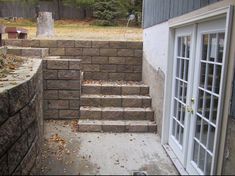 an outdoor area with steps leading up to the back door