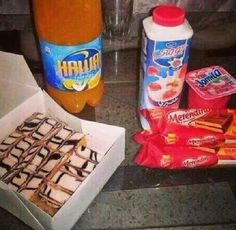 there are some snacks and drinks on the counter next to each other, including milkshake