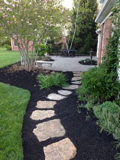 a stone path in the middle of a garden