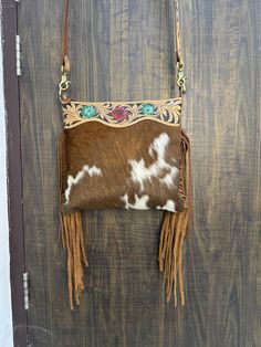 Discover the timeless charm of our Leather Cowhide Fringe Crossbody Purse! Handcrafted with love, this top-handle bag merges rustic elegance with modern style. Perfect for her, its versatile design complements any outfit. Treat someone special to this western-inspired shoulder bag--now on sale! Don't miss out! Dimensions: 12" (Height) x 12.5" (Width) -Premium Leather -Hand Tooled Leather -Adjustable Leather Strap Hand Tooled Western Bags, Western Style Shoulder Bag For Everyday, Western Brown Bag With Adjustable Strap, Western Style Rectangular Bag With Adjustable Strap, Western Style Brown Bags For Daily Use, Western Brown Shoulder Bag With Adjustable Strap, Western Brown Satchel Shoulder Bag, Western Hand Tooled Bags For Daily Use, Western Style Brown Shoulder Bag With Adjustable Strap