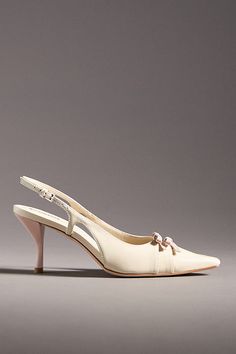 The Reformation Noreen Slingback Heels exude vintage charm with their elegant slingback design, pointed toe, and delicate bow details. | Noreen Slingback Heels by Reformation in White, Women's, Size: 5.5, Leather/Rubber at Anthropologie Grad Outfits, The Reformation, Slingback Heels, Shoes Heels Wedges, Slingback Heel, Heels & Wedges, Shoe Closet, Vintage Inspired Design, Shoe Shop