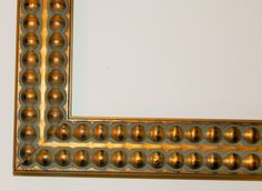 an ornate gold framed mirror on the wall