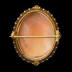 In the 19th century, a slew of archaeological discoveries in Italy spawned a renewed interest in classical history — including jewelry! This style is called "Etruscan Revival," named for Etruria, an ancient civilization near Rome that predated its founding and influenced its culture. This cameo is made of shell and features an ornate carving of the Three Graces, daughters of Zeus who bestowed what is most pleasurable and beneficent in nature and society: Euphrosyne (mirth), Aglaia (elegance) and Ancient Ceremonial Hallmarked Jewelry, Historical Yellow Gold Engraved Jewelry, Traditional Oval Jewelry With Historical Design, Antique Cabochon Jewelry For Ceremonial Occasions, Historical Yellow Gold Jewelry For Ceremonial Use, Historical Yellow Gold Jewelry For Ceremonies, Historical Yellow Gold Jewelry For Ceremonial Occasions, Historical Ceremonial Yellow Gold Jewelry, Historical Yellow Gold Jewelry For Wedding