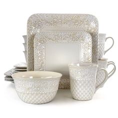 a set of white dishes and cups sitting on top of each other