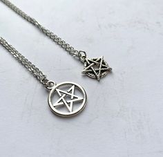 This handmade necklace features a silver plated pentagram charm. Handmade with a quality 18 inch stainless steel chain and matching lobster clasp.  Product details Pentagram charm is silver plated; limited quantity. You may also choose charm only, no chain. If so, you will receive your charm on a matching silver ring. Free shipping on orders over $35  Check out more necklaces here: https://www.etsy.com/shop/AnEnchantingCreature?ref=seller-platform-mcnav&section_id=21978338 Thank you for supporti Silver Star-shaped Metal Necklace, Adjustable Silver Charm Necklaces With Star Charm, Star-shaped Metal Necklaces As Gift, Star-shaped Metal Necklaces For Gifts, Adjustable Sterling Silver Charm Necklaces With Star Charm, Star-shaped Metal Necklace As Gift, Silver Star-shaped Adjustable Necklace, Star-shaped Metal Necklace Gift, Adjustable Sterling Silver Star Charm Necklace