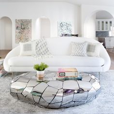 a living room with a white couch and coffee table in it's center area