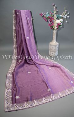 This dark mauve saree and blouse set is elegantly embroidered with stones and crystals, adding a touch of glamour to your look. Made from soft and easy to drape organza fabric, it offers comfort and effortless style. Perfect for special occasions and wedding events. Elegant Purple Chanderi Pre-draped Saree, Unstitched Purple Pre-draped Saree With Dori Work, Elegant Purple Tissue Silk Pre-draped Saree, Purple Semi-stitched Chinon Blouse Piece, Purple Embroidered Georgette Fabric Saree, Purple Embroidered Georgette Pre-draped Saree, Elegant Purple Georgette Embroidered Fabric, Unstitched Purple Chinon Saree, Elegant Purple Embroidered Georgette Fabric