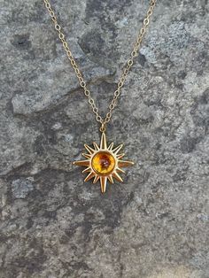 This necklace is handmade with a 19mm by 21mm 14k gold-plated stainless steel pendant and a 6mm genuine citrine cabochon. The chain is 14k gold-filled and will not tarnish.  This necklace is hypoallergenic. (Cadium free, lead free, and nickel safe) Citrine is a stone that promotes positive energy, abundance, and strength. Please note that each stone is unique and varies in color. The necklace comes in a ribbon-tied gift box and if you would like to leave a note, you can do so during checkout. Gold Stainless Steel Jewelry With Birthstone, Gold-toned Stainless Steel Jewelry With Birthstone, Gold Sterling Silver Jewelry With Cabochon, Everyday Round Citrine Jewelry, Everyday Citrine Jewelry, Yellow Round Brass Jewelry, Everyday Round Amber Jewelry, Sun-shaped Jewelry With Sun And Moon Design For Gift, Yellow Tarnish-resistant Jewelry