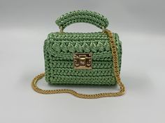 Product Title: Handbag For Woman,Handmade Metallic Bag,Gold Metallic Bag,Luxury Gold Woman Bag,Evening Crochet Bag,Knitted Metallic Shoulder Bag ✨Product Description: This hand-woven bag is a true masterpiece. It is meticulously crafted with 100% metallic yarn, making it not only beautiful but also durable. ✨The bag is lined inside and offers ample space to carry all your essentials. The lining is carefully sewn in to match the color of the handmade metallic bag, adding an extra touch of eleganc Green Rectangular Evening Bag, Handmade Green Shoulder Bag, Green Rectangular Evening Bag With Top Handle, Luxury Rectangular Crochet Bag With Top Handle, Luxury Rectangular Crochet Bag With Top Carry Handle, Luxury Everyday Rectangular Crochet Bag, Green Handmade Everyday Satchel, Luxury Rectangular Crochet Bag With Removable Pouch, Green Rectangular Crochet Bag With Removable Pouch