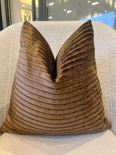 a brown pillow sitting on top of a white couch