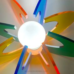 a multicolored light fixture with multiple colored strips on it's center piece