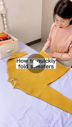 a woman sitting at a table with a yellow sweater on it's lap, and the words how to quickly fold sweaters