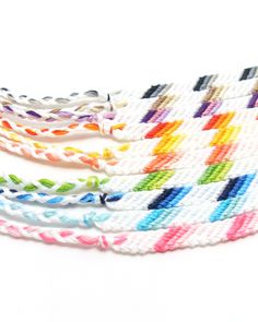 multicolored braided bracelets on white background