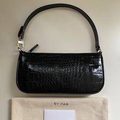 By Far Rachel Bag Color: Black Size : One Size New * Leather: Cowhide Croc-Embossed Leather Zip At Top Dust Bag Included Lined Weight: 9oz / 0.26kg Height: 5in / 13cm Length: 11in / 28cm Depth: 1.5in / 4cm Handle Drop: 7.5in / 19cm Designer Black Handheld Baguette Bag, Black Handheld Baguette Bag With Removable Pouch, Luxury Black Baguette Bag With Adjustable Strap, Black Shoulder Bag For Office With Dust Bag, Black Baguette Clutch For Daily Use, Black Clutch Baguette Bag For Daily Use, Black Shoulder Evening Bag With Zipper Closure, Black Evening Shoulder Bag With Zipper Closure, Black Tote Baguette Bag With Detachable Strap