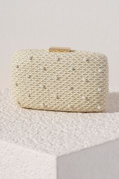 Add a touch of elegance to your summer accessories with Shiraleah's Lola Minaudiere. With a simple netted ivory background, the faux pearl details are the star of the show on this purse. You can carry it as a clutch, or use the detachable cross-body chain to add some versatility to your style. Pair with other items from Shiraleah to complete your look! Features A Detachable Cross-Body Chain And Pick-Lock Closure Shiraleah Is A Trend-Driven Lifestyle Brand Focused On The Little Gifts That Make Life Special! Made From Polypropylene And Faux Pearls, With Gold Hardware Measures L 7" X W 2" X H 4.25"; Chain 23" Made In China Feminine Beige Evening Bag, Beige Feminine Evening Bag, Feminine Beige Rectangular Evening Bag, Feminine Gold Rectangular Clutch, Elegant Rectangular Evening Bag For Spring, Elegant Rectangular Spring Evening Bag, Cream Bags For Spring Party, Feminine Beige Clutch For Evening, Elegant Beige Clutch For Summer