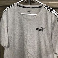 T Shirt ,Nwot Gray With White And Black Puma On Sleeves Size Large, Pit Is 23” ,Length Is 28” Sporty Crew Neck Top With Puma Logo, Sporty Puma Logo Crew Neck Top, Sporty Puma Logo Tops For Sports, Sporty Puma Tops For Sports, Sports Crew Neck Top With Puma Logo, Crew Neck Sports Top With Puma Logo, Puma Logo Crew Neck Sports Top, Puma Logo Cotton Tops For Athleisure, Athleisure Cotton Tops With Puma Logo