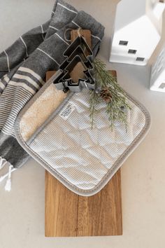 a cutting board and pot holder are sitting on the counter