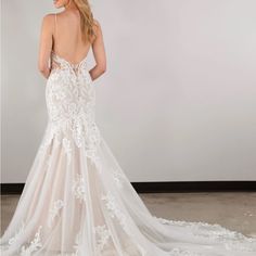 a woman in a white wedding dress looking back