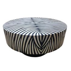 a black and white coffee table with an unusual design on it's top, in the shape of a zebra print