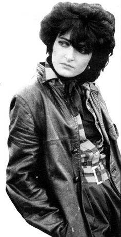 black and white photograph of a woman in a leather jacket with her hands on her hips