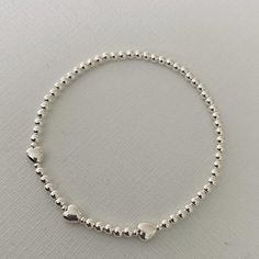 Pretty sterling silver beaded stretch handmade stacking bracelet. Made using 2mm and 3mm Sterling silver round beads and heart beads, hand strung on strong jewellers elastic. A perfect addition to your stacking collection or gorgeous on its own. Bracelets measure 18cm un stretched however each bracelet is made to order so can be made any size you require. Please just advise us when you are ordering.Packaged in branded jewellery box and posted in Jiffy bag. Bracelets Stack, Branded Jewellery, Bracelet With Heart, Bracelet Set Silver, Feather Bracelet, Sterling Silver Bead Bracelet, Stacking Bracelets, Rose Gold Beads, Bracelet Heart