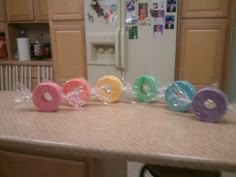 several rolls of toilet paper sitting on top of a counter in front of a refrigerator