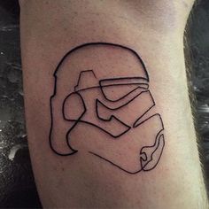 a star wars tattoo on the leg of a man with a helmet drawn on it