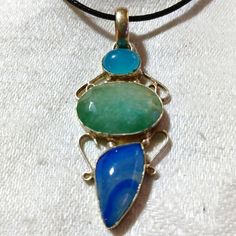 This Is A Gorgeous, Handmade, Amazonite, Blue Lace Agate, And Chalcedony Pendant Necklace. This Piece Of Silvery Jewelry Is Gorgeous And I Really Debated Keeping This One! I Love It! The Pendant Measures Approximately 2"X 1". The Pendant Comes With A Black Corded Necklace With An Extension. I Hope You Like It. Thanks For Stopping By And Feel Free To Leave Me A Fair Offer. :) Blue Agate Pendant Jewelry, Handmade Blue-green Bohemian Jewelry, Blue Agate Gemstone Necklaces, Blue Agate Gemstone Necklace, Unique Blue Agate Jewelry, Blue Chalcedony Jewelry With Natural Stones, Handmade Blue-green Necklaces For Gifts, Handmade Blue-green Necklace For Gift, Adjustable Blue Agate Necklace