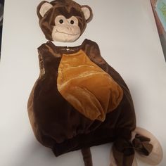 a monkey stuffed animal sitting on top of a table