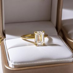 an emerald cut diamond sits in a box