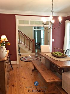 a dining room table with two benches in front of it and a bowl of fruit on the table