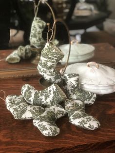 several pieces of porcelain sitting on top of a wooden table next to a tea pot