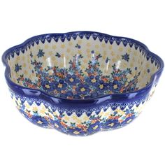 a blue and white bowl with flowers on it