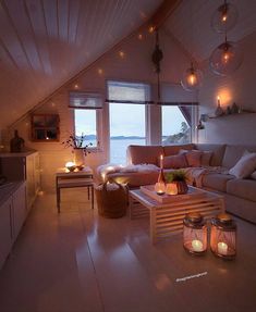 a living room filled with furniture and candles