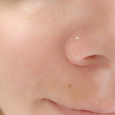 a close up view of a person's nose and nose with small white dots on it