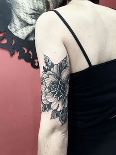 a woman's arm with a flower tattoo on the left side of her body