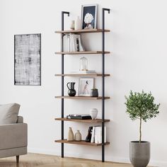 a living room with a couch, chair and book shelf on the wall in front of it