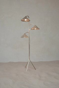 a lamp that is sitting on top of a table next to a white wall and floor