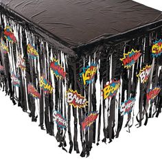 a table covered in black plastic and decorated with comic logos on it's sides