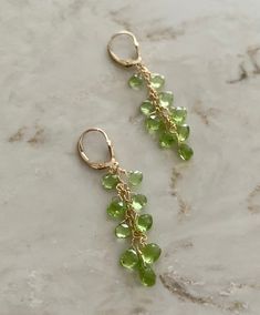 These are peridot drop earrings using 9 pear shaped stones in each, and wire wrapped with 14 k gold filled. They hang about 2.25 inches and are really easy to put on, using a lever back closure. Great the for the up coming holidays, great for gifts and great for evening wear. Not too long, not too short, they're just right. peridot drop earrings peridot and gold dangling earrings holiday earrings August birthstone earrings Peridot Dangle Earrings For May Birthstone, Green 14k Gold-filled Dangle Earrings, Green 14k Gold Filled Dangle Earrings, Peridot Dangle Earrings With Ear Wire, Green 14k Gold Dangle Earrings, Peridot Dangle Earrings In Gold, Green Teardrop 14k Gold Filled Earrings, Peridot Teardrop Earrings For May Birthstone, Teardrop Peridot Earrings For May Birthstone