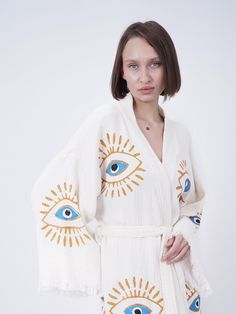 Introducing our exquisite organic cotton Handmade Evil Eye Boho Festival Kimono, a mesmerizing blend of bohemian elegance and spiritual symbolism. Handcrafted with love and care, this kimono is a stunning addition to your festival wardrobe, offering both style and positive energy. Our bohemian kimono, which is made of 100% handmade high quality cotton fabric, can be used as a pareo in daily life or on the beach. (Made in Turkey) All of our ultra soft products are OEKO-TEX Standard 100 Certified. Bohemian V-neck Cardigan For Loungewear, Folk Style Cotton Kimono For Spring, White Relaxed Fit Cotton Cardigan, White Relaxed Fit Summer Cardigan, White Relaxed Fit Cardigan For Summer, Beach Cotton V-neck Cardigan, Beach V-neck Cotton Cardigan, White Cotton Folk Kaftan, Bohemian Cotton Cardigan For Loungewear