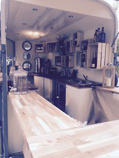 a kitchen with wooden counter tops and shelves